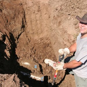 Guy digging dirt with a showel