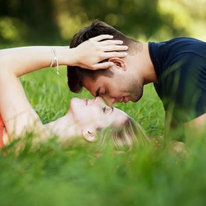 Lovers cuddling in the grass