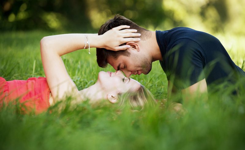 Lovers cuddling in the grass