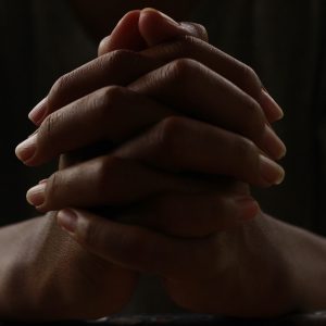 Person holding hands and praying