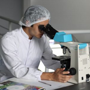 Scientist using microscope