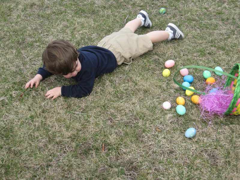 Kid laying after fall on a grass