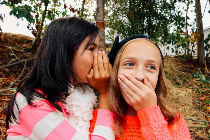 Two girls gossiping