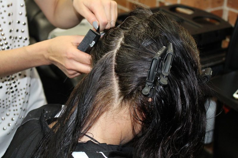 Hairdresser making haircut