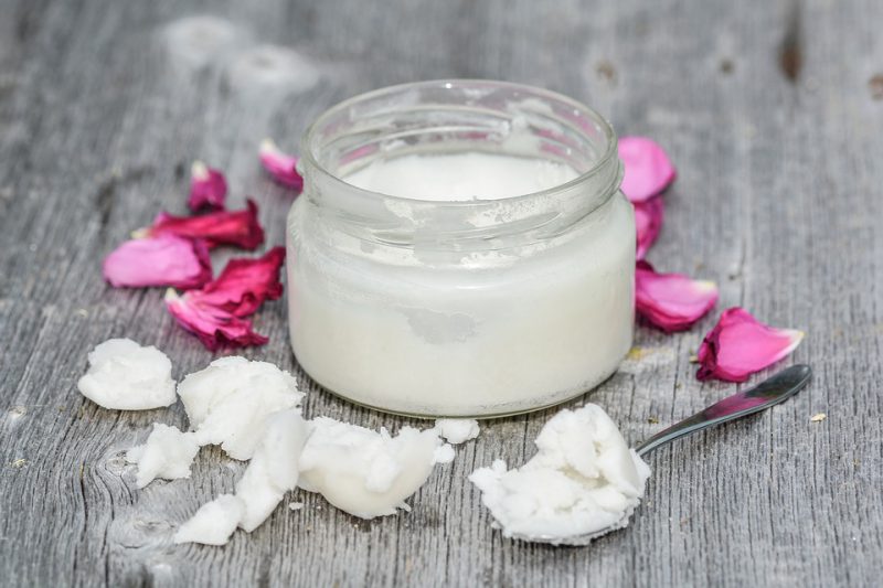 Ointment in a gallon with rose petals around it