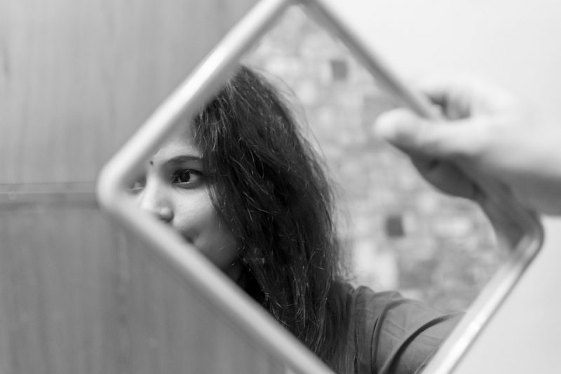 Girl looking into mirror