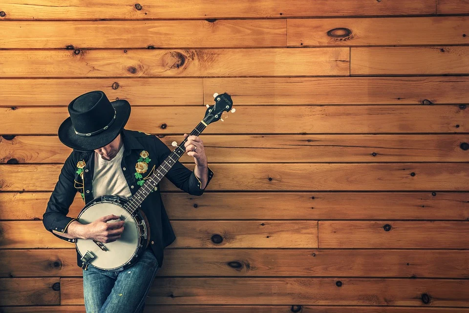 A musician holds an instrument and plays