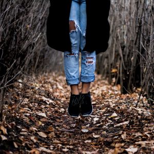 Women's legs hang above the ground