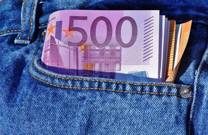 A roll of euros in a jeans pocket