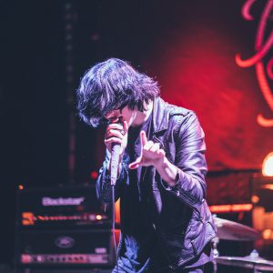 A man sings on the podium