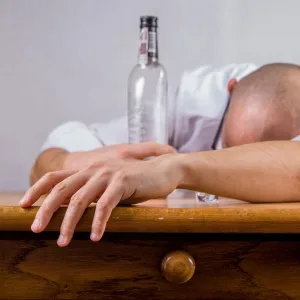 A drunk man sleeps on the table