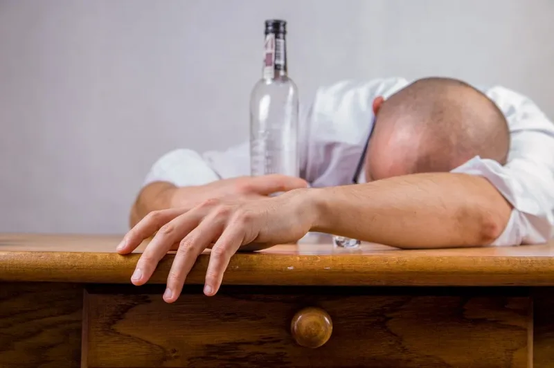 A drunk man sleeps on the table