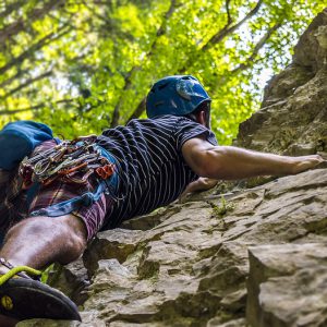 A mountaineer climbs a rock