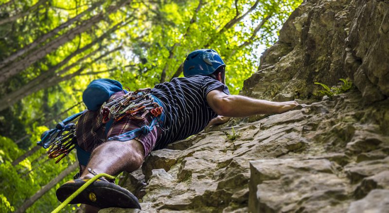 A mountaineer climbs a rock