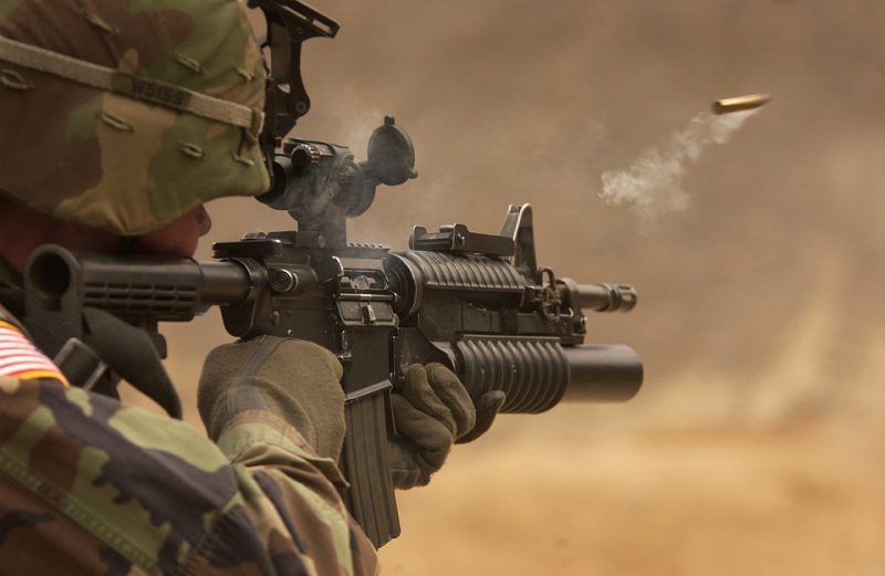 A soldier fires a rifle