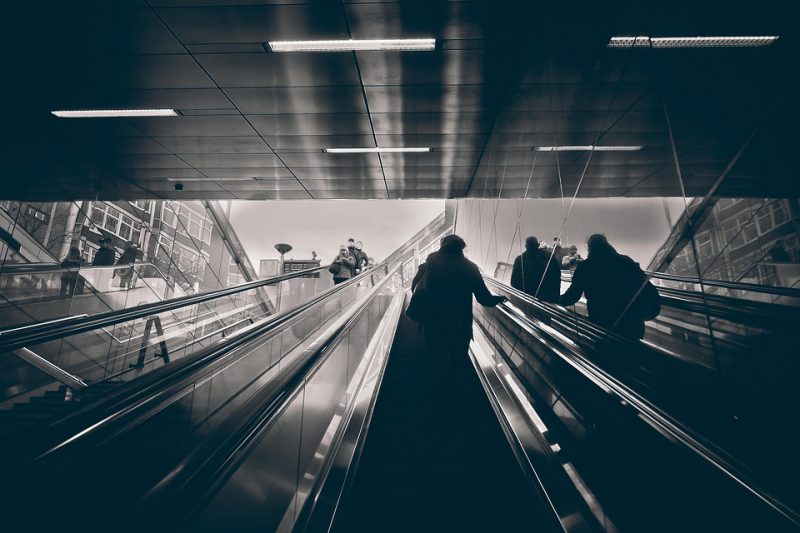 People move on escalators