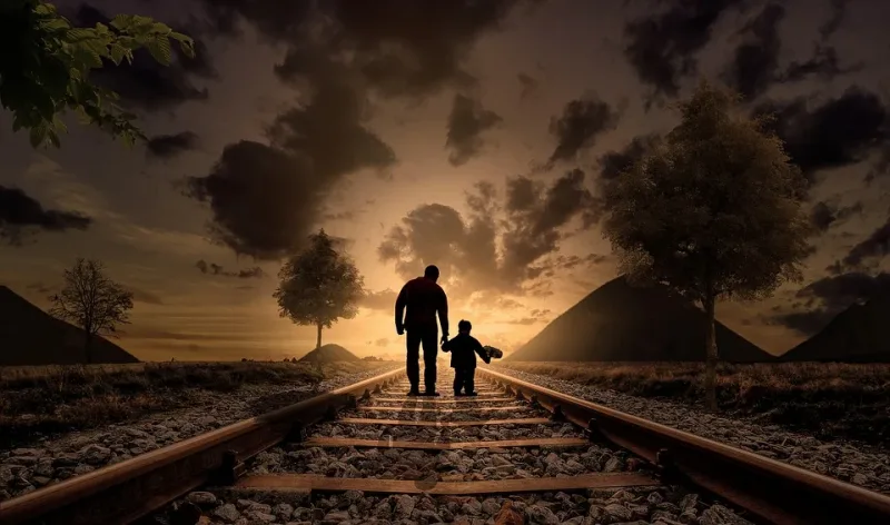 Father and son are walking on the railway