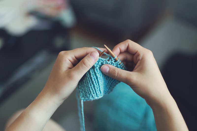 A child learns to knit