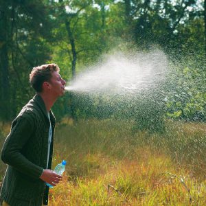 A man spits water from his mouth