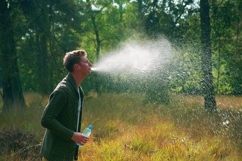 A man spits water from his mouth