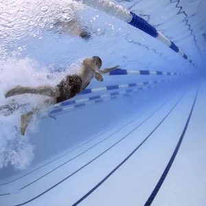 A man is swimming in a pool