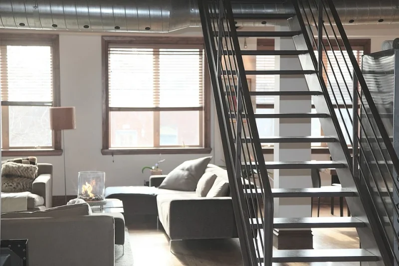 Living room of the apartment with stairs to the second floor