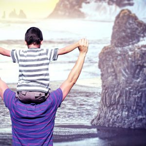 Uncle and nephew playing on the seashore