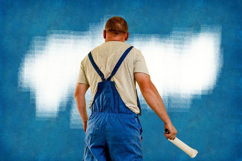 Upholsterer prepares the wall