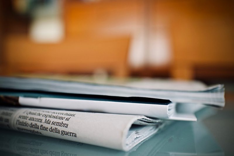 Folded up newspaper left on the desk