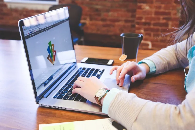 Profile picture of a woman working on a laptop