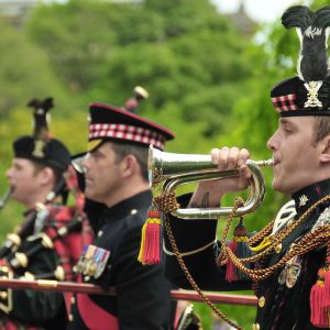 A man in a parade holds a bugle