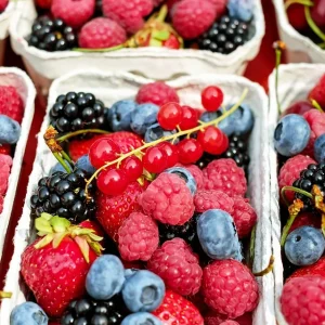 Berries displayed in small containers for sale