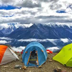 Three tents set up in the mountains