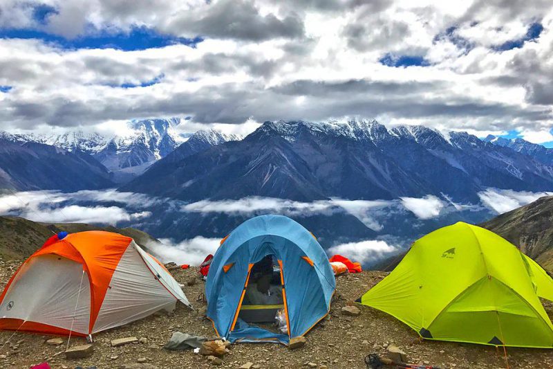Three tents set up in the mountains