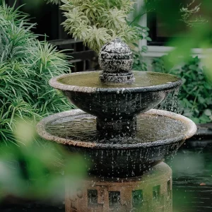 A garden fountain with various greenery around it