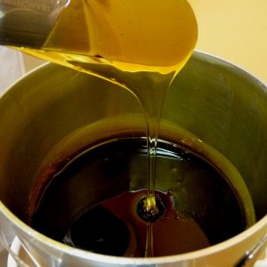Melted wax poured into a tin bucket