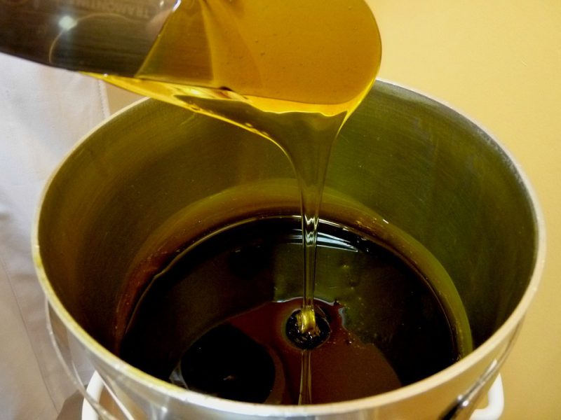 Melted wax poured into a tin bucket