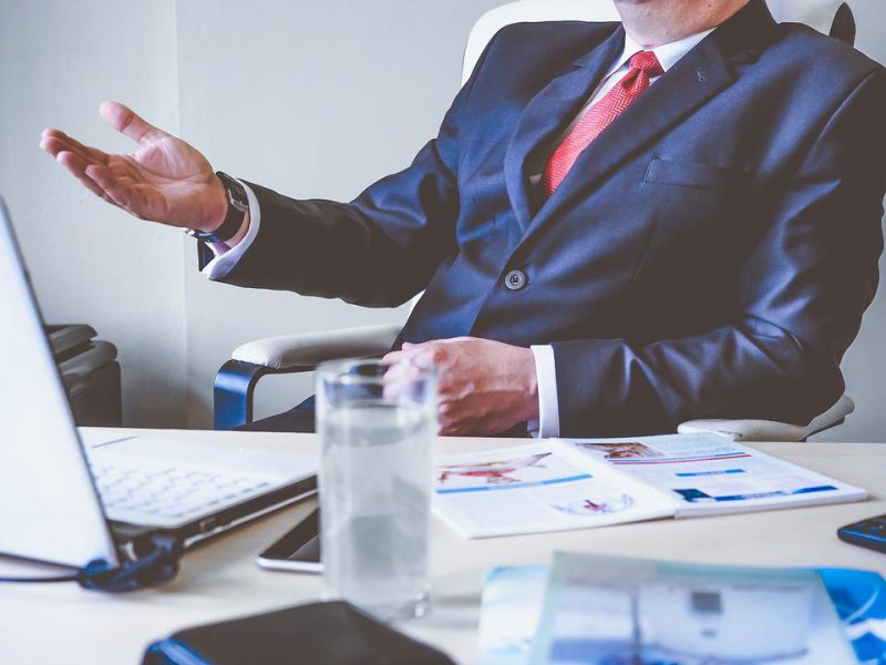 A man in a suit is sitting in the office