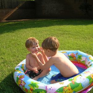 Children play in a small inflatable pool