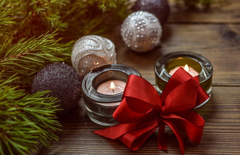 Christmas decorations and burning candles on display