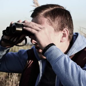 A person looks through binoculars