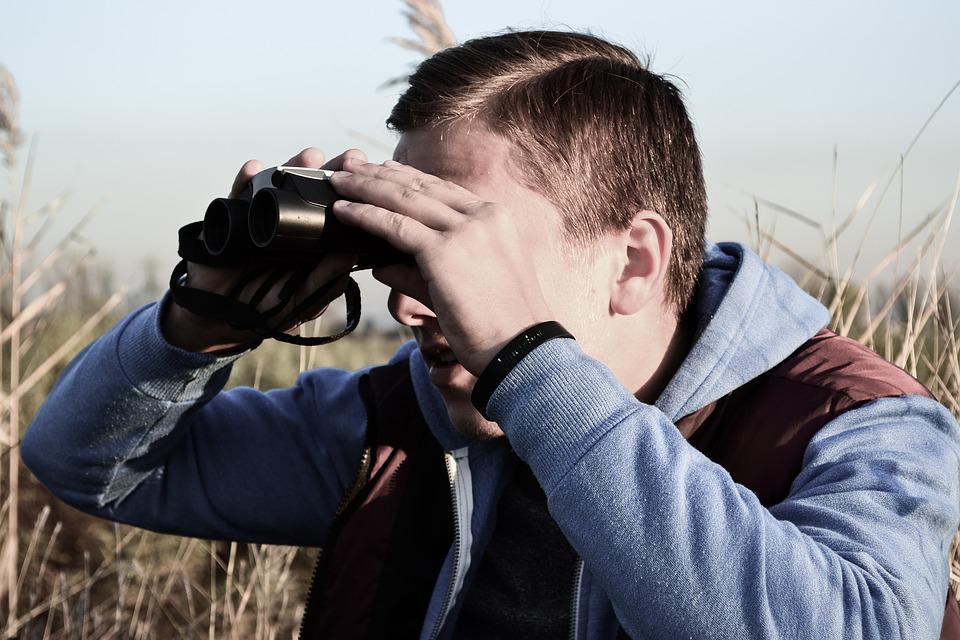 A person looks through binoculars