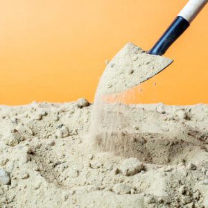 Digging sand with a shovel