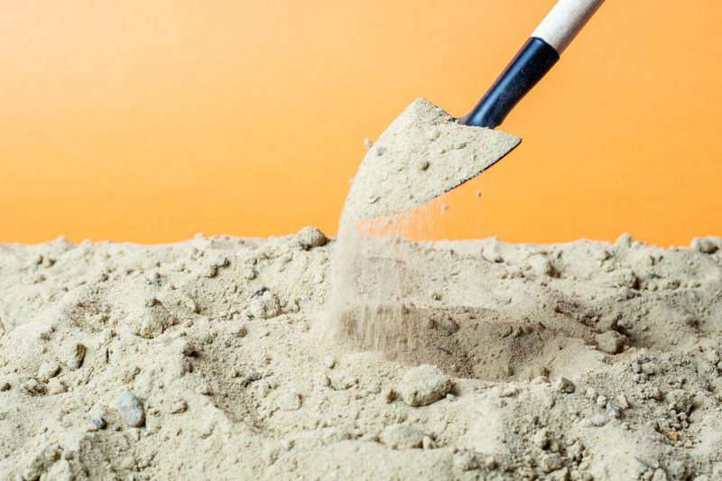 Digging sand with a shovel