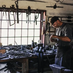 Craftsman is making something in his workshop