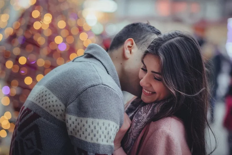 A man hugging and kissing a woman