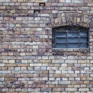 Brick wall with a small window