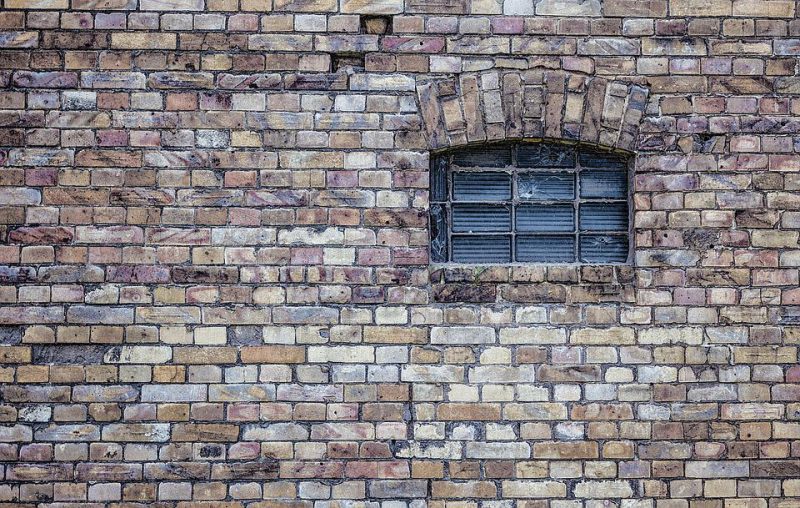 Brick wall with a small window
