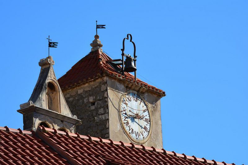 Old tower with clock and bell