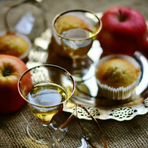 Drinks, apples and muffins on a tray